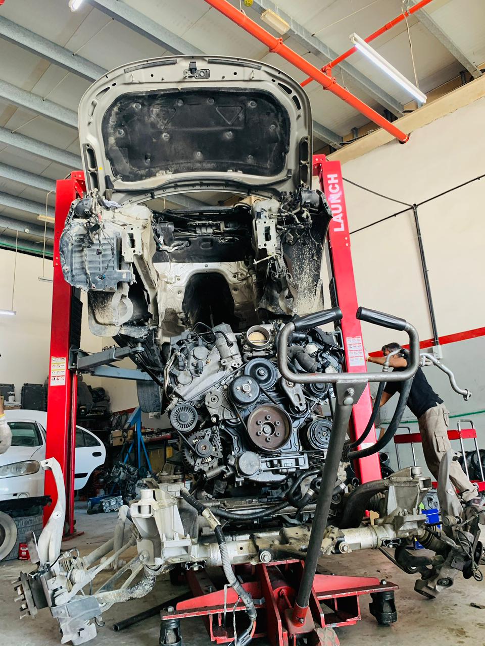 Technician inspecting an engine bay